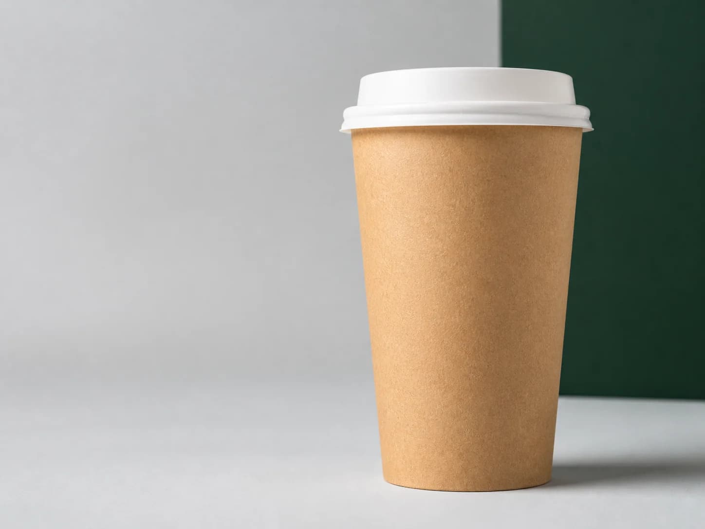 Blank kraft paper cup in a clean studio setting